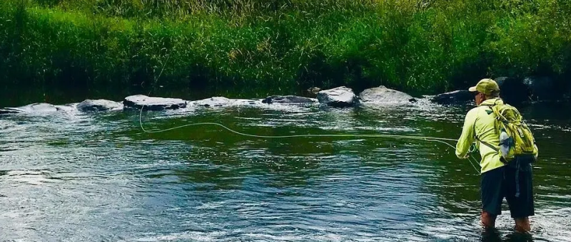 A river with green water and rocks in it.