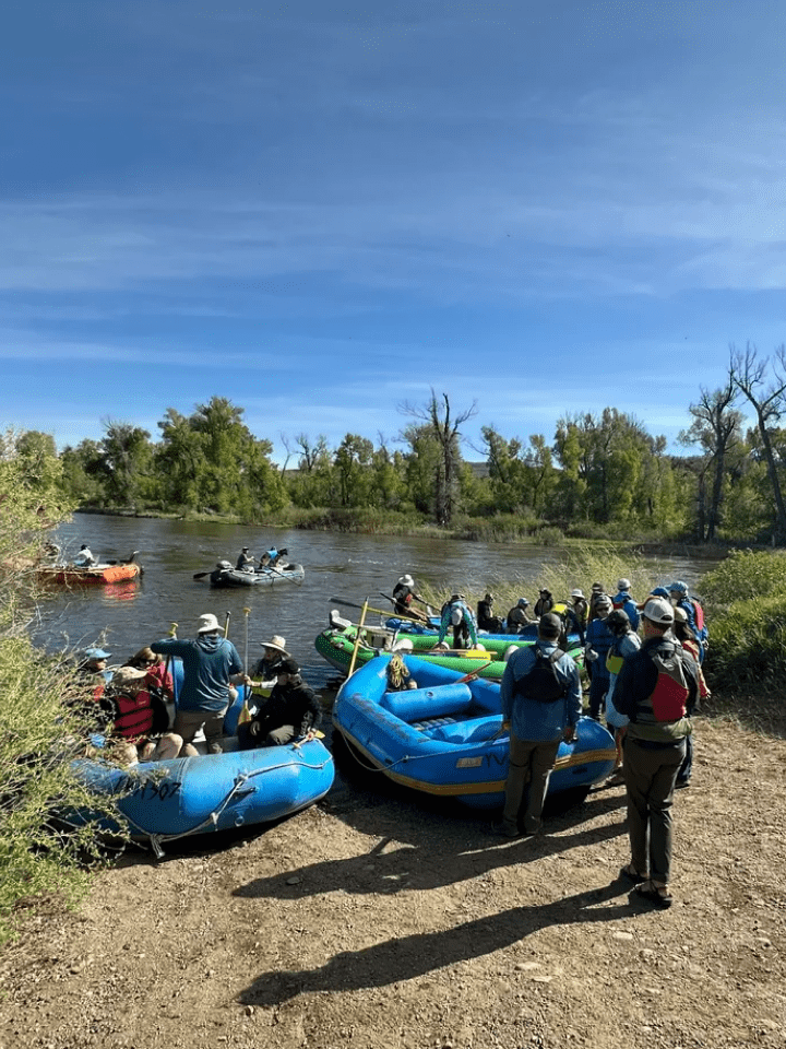 A group of people in rafts on the river.