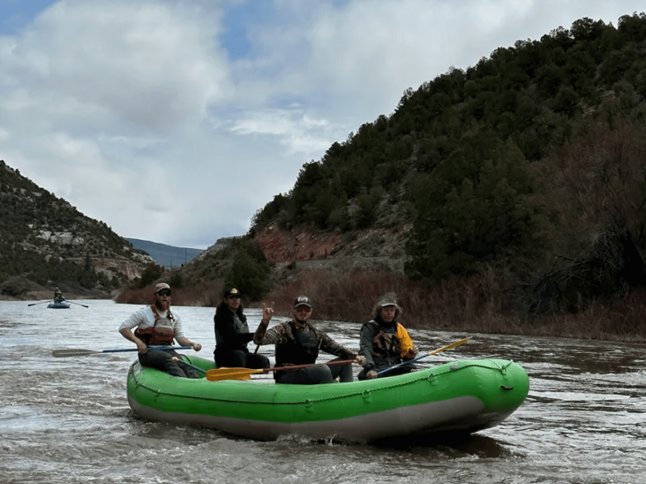 A group of people in a raft on the river.