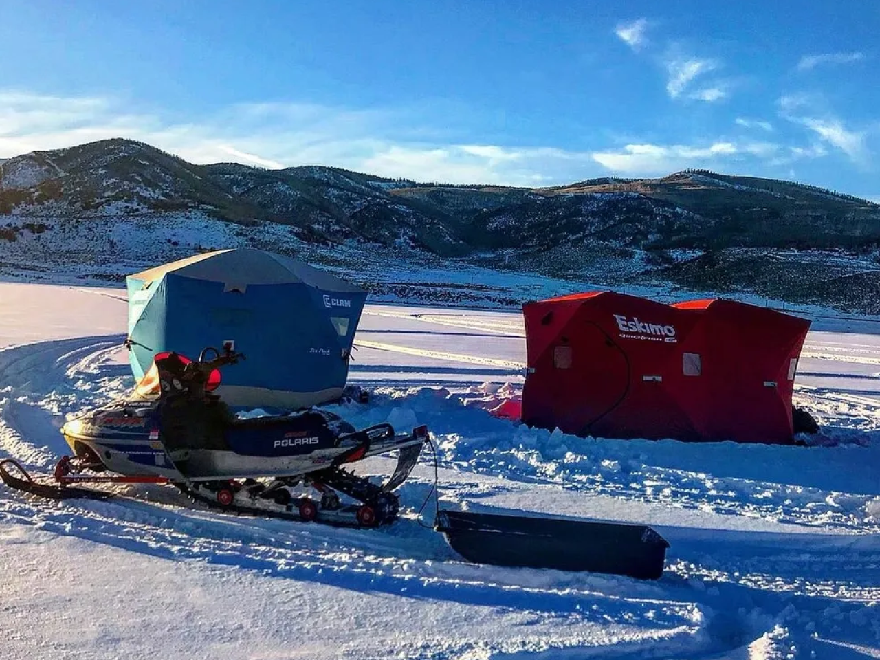 A person on snowmobile in the snow.