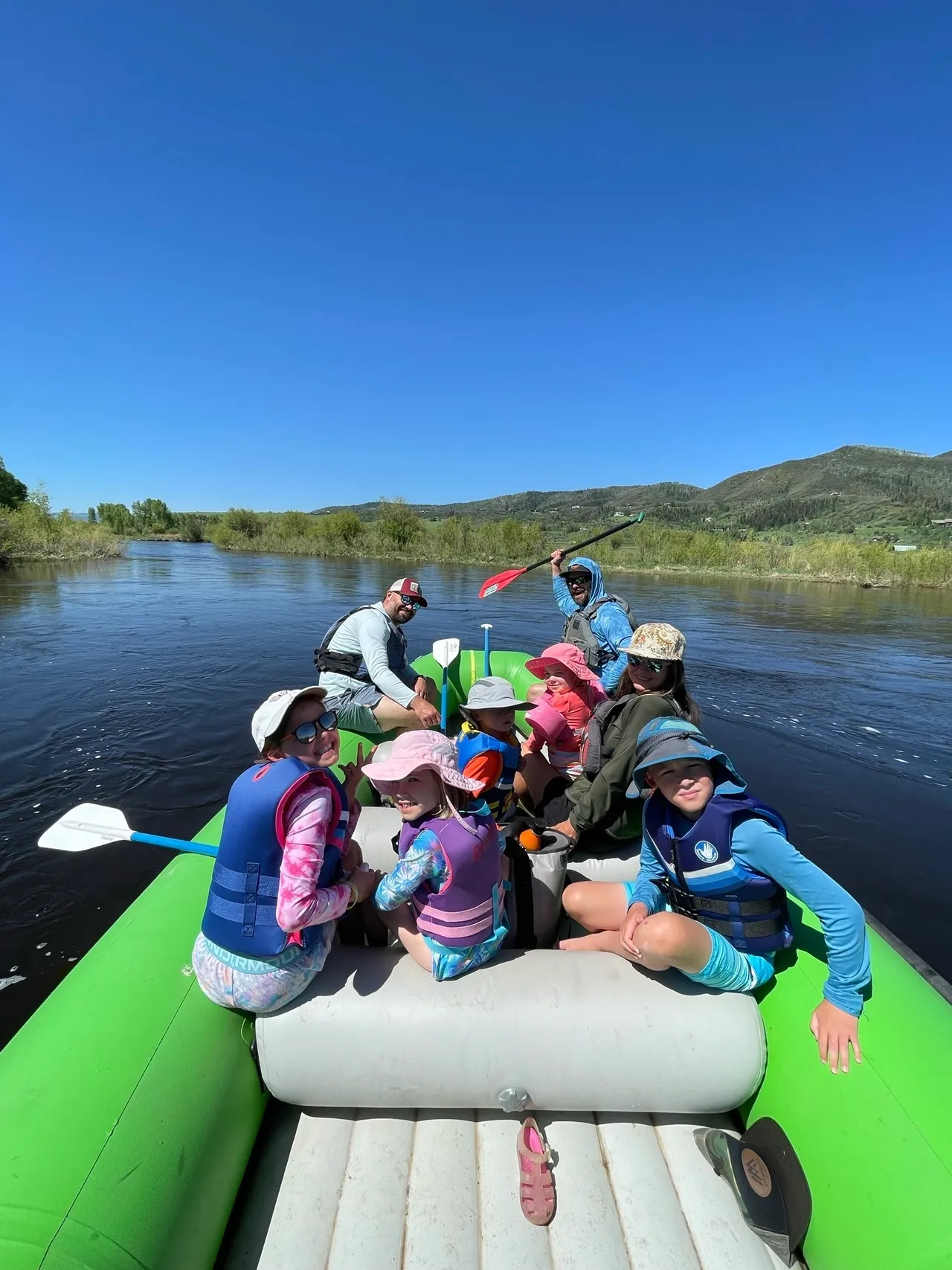 A group of people on a raft in the water.