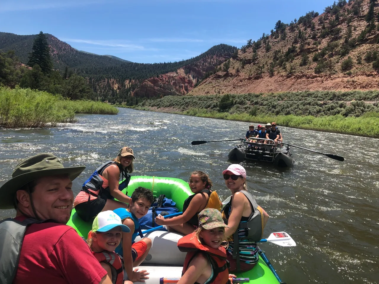 A group of people on a raft in the water.