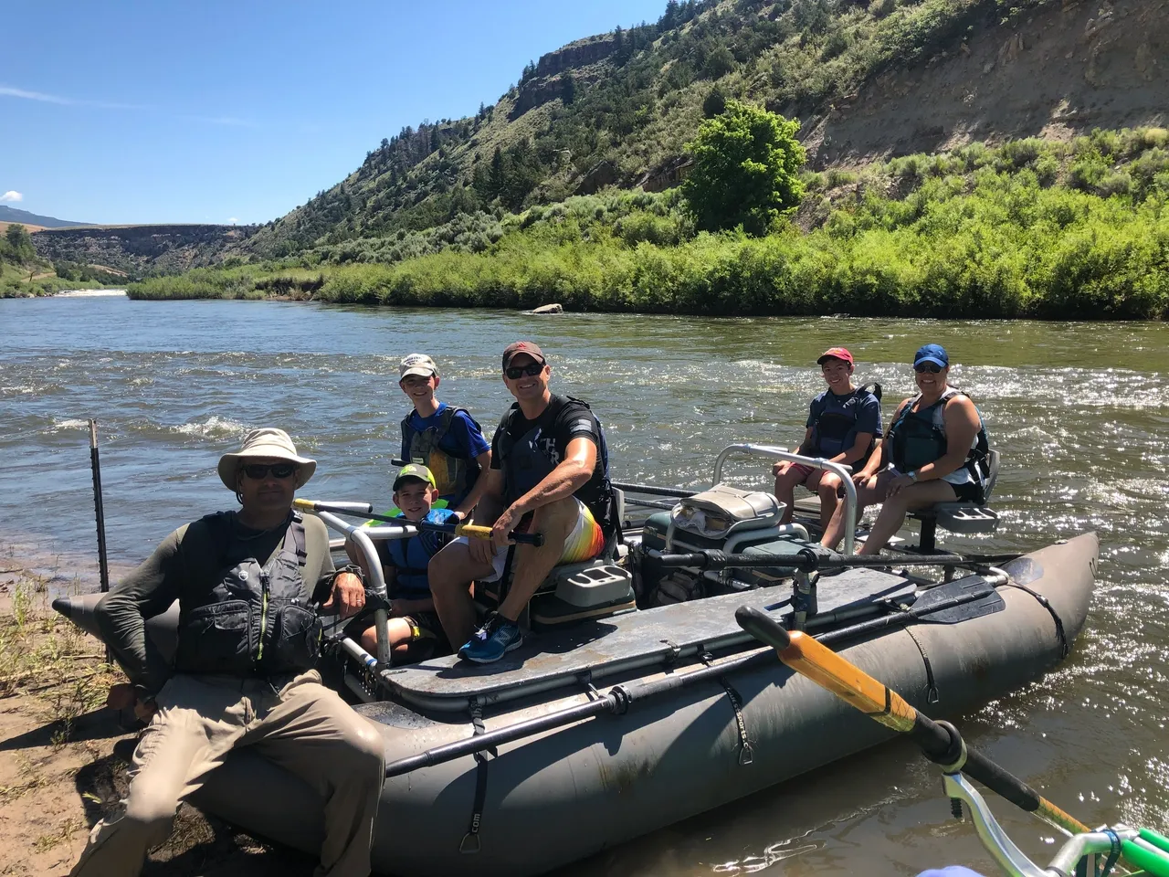 A group of people in a raft on the water.