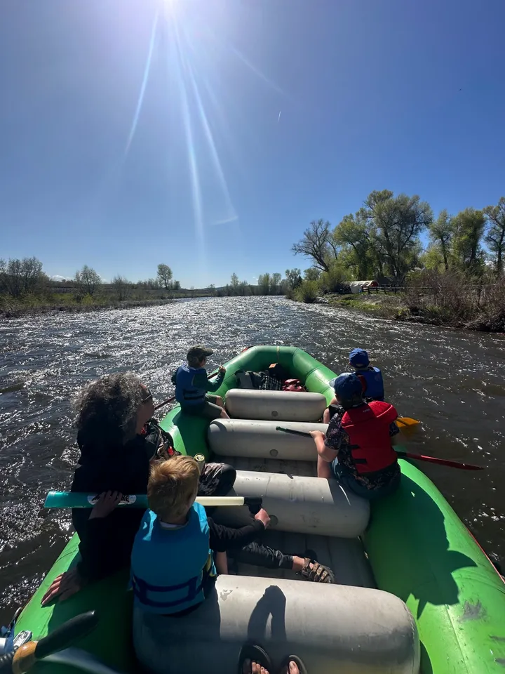 A group of people in a raft on the river.