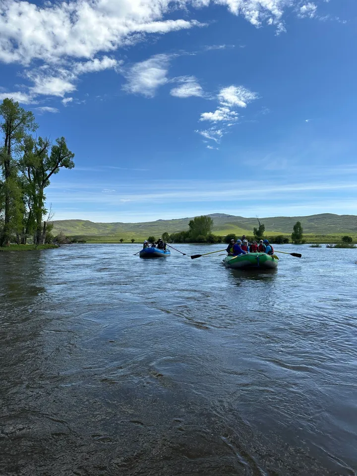 Two people in a raft on the river.