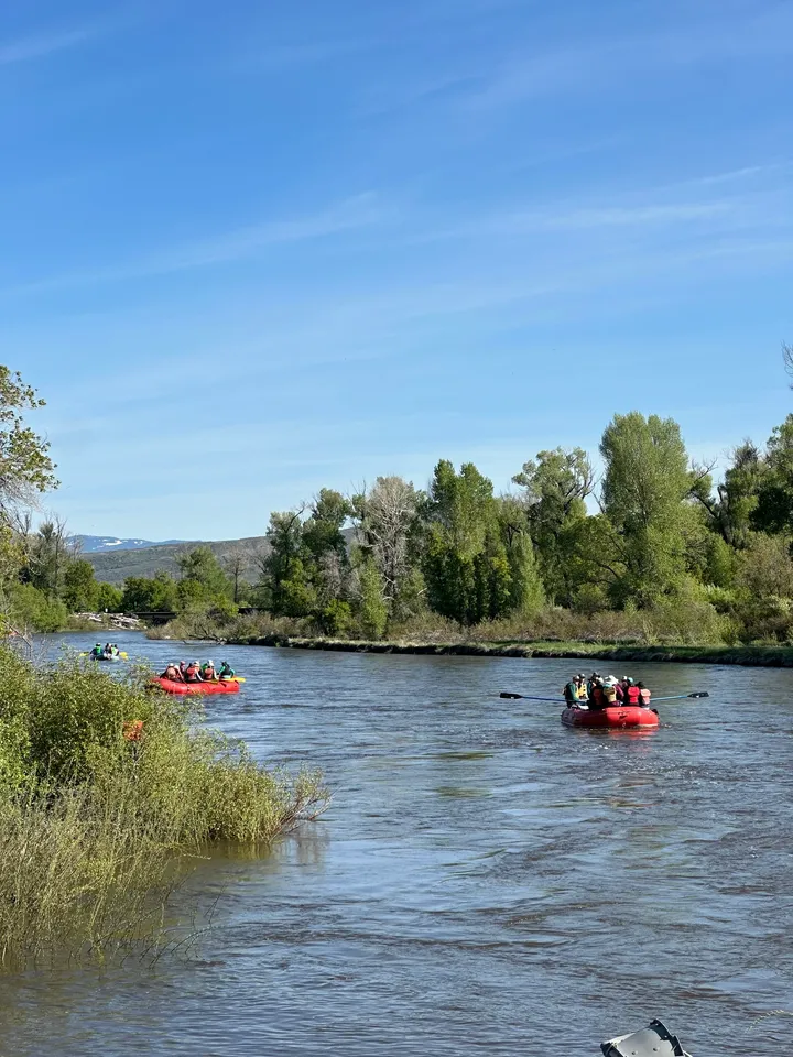 A group of people in rafts on the river.