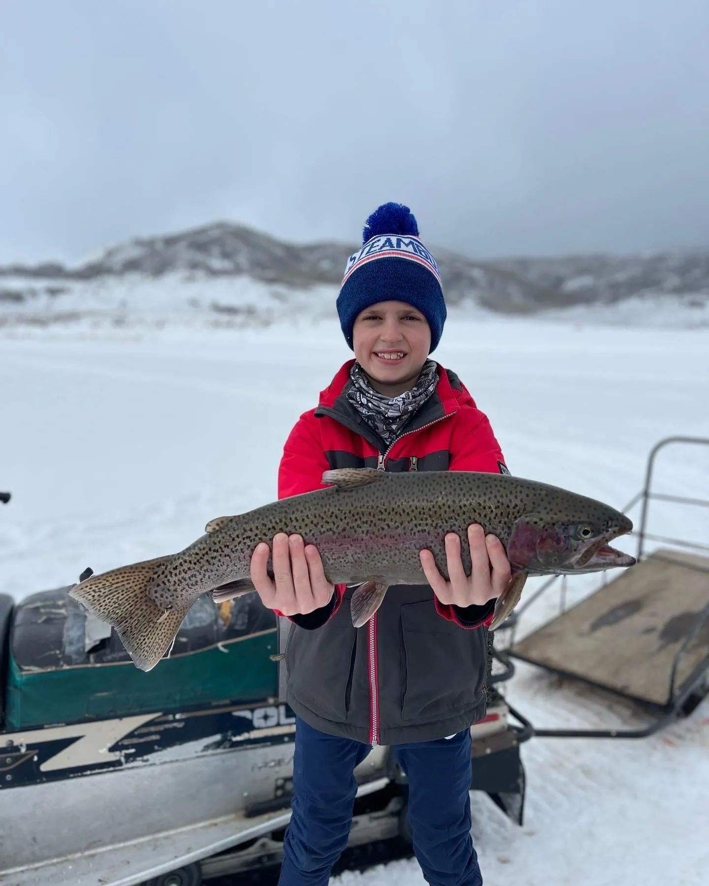 A boy holding a fish in his hands.