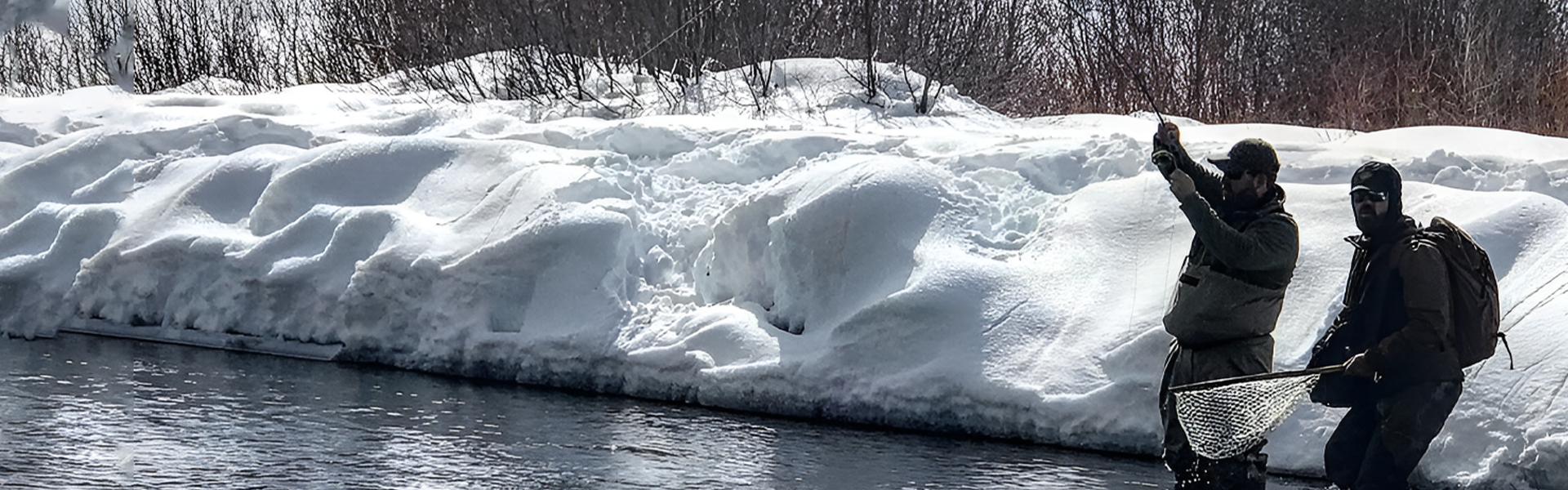 A body of water with snow on it