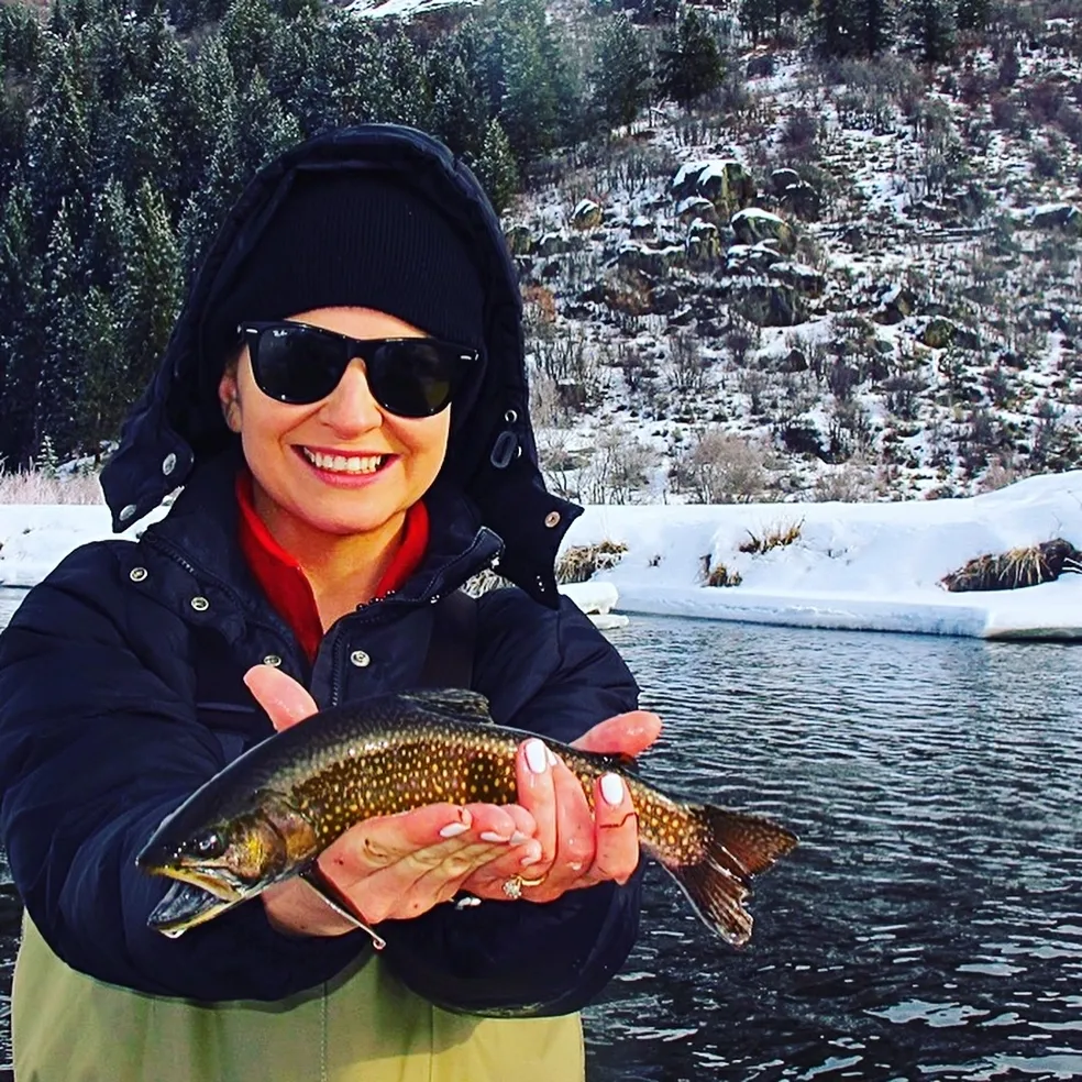 A woman holding a fish in her hands.